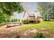 Spacious backyard with an above ground pool, wooden deck, mature trees, and plenty of privacy at 200 Scouts Ridge Dr, Covington, GA 30016