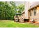 Expansive backyard featuring a wooden deck, mature trees, and lush green grass, perfect for outdoor activities at 200 Scouts Ridge Dr, Covington, GA 30016
