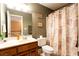Standard bathroom features a framed mirror, a toilet and a shower/tub combination with a patterned curtain at 200 Scouts Ridge Dr, Covington, GA 30016