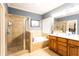 Bright bathroom featuring a walk-in shower, a tub, and vanity cabinets at 200 Scouts Ridge Dr, Covington, GA 30016