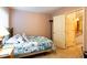 Bright bedroom features a bed, a night stand, and a doorway leading to a hallway at 200 Scouts Ridge Dr, Covington, GA 30016
