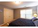 Well-lit bedroom with double closet doors and a bright window looking out to the surrounding greenery at 200 Scouts Ridge Dr, Covington, GA 30016
