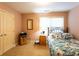 Cozy bedroom with light pink walls, carpet flooring, and a bright window providing natural light at 200 Scouts Ridge Dr, Covington, GA 30016
