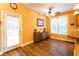 Bright dining area featuring wood floors, a ceiling fan, and a side entrance to the yard at 200 Scouts Ridge Dr, Covington, GA 30016