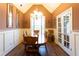 Formal dining room with wainscoting, chandelier, and hardwood floors at 200 Scouts Ridge Dr, Covington, GA 30016