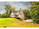 Charming tan home with a stone façade, lush lawn, and above ground pool on a hillside lot at 200 Scouts Ridge Dr, Covington, GA 30016