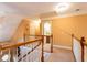 Spacious hallway with wooden railing leading to a landing area; painted with a warm neutral color at 200 Scouts Ridge Dr, Covington, GA 30016