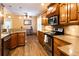 Well-lit kitchen featuring wooden cabinets and stainless steel appliances at 200 Scouts Ridge Dr, Covington, GA 30016