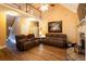 Comfortable living room with a fireplace, wood floors, and a staircase to the upper level at 200 Scouts Ridge Dr, Covington, GA 30016
