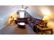 Attic space transformed to a living room boasts a plush brown sectional sofa and coordinated decor at 200 Scouts Ridge Dr, Covington, GA 30016