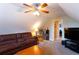 Attic living room features a ceiling fan, comfortable sofa and an access to another bedroom at 200 Scouts Ridge Dr, Covington, GA 30016