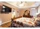 Comfortable bedroom with a tray ceiling, wood flooring, and access to the en-suite bathroom at 200 Scouts Ridge Dr, Covington, GA 30016