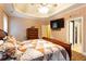 Relaxing bedroom featuring a tray ceiling, wood flooring, and access to the en-suite bathroom at 200 Scouts Ridge Dr, Covington, GA 30016