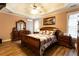 Spacious main bedroom with wood floors, a tray ceiling, and a decorative mirror at 200 Scouts Ridge Dr, Covington, GA 30016