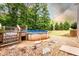 Above-ground pool with deck access and gravel surround, set against a backdrop of lush trees at 200 Scouts Ridge Dr, Covington, GA 30016