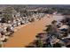 Aerial view of lake community showing lakefront homes surrounded by trees at 251 Waterford Cove Dr, Suwanee, GA 30024