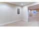 View of the finished basement showing neutral carpeting and window at 251 Waterford Cove Dr, Suwanee, GA 30024