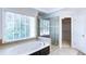 Relaxing primary bathroom with a jetted tub, glass-enclosed shower, and a large window for plenty of natural light at 251 Waterford Cove Dr, Suwanee, GA 30024