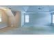 Spacious carpeted bedroom featuring a tray ceiling, ceiling fan, and large windows to allow plenty of natural light at 251 Waterford Cove Dr, Suwanee, GA 30024