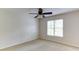 Bedroom with a ceiling fan and a large window that lets in natural light at 251 Waterford Cove Dr, Suwanee, GA 30024