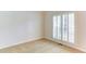 Small bedroom with light walls, carpeted floor, and plantation shutters on the window at 251 Waterford Cove Dr, Suwanee, GA 30024