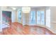 Bright dining area with hardwood floors, a large chandelier, and large windows with plantation shutters at 251 Waterford Cove Dr, Suwanee, GA 30024