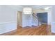 Bright dining area with hardwood floors, wainscoting, and view into carpeted stairwell at 251 Waterford Cove Dr, Suwanee, GA 30024