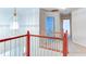 View of upstairs hallway with an elegant hanging light fixture at 251 Waterford Cove Dr, Suwanee, GA 30024