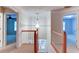 Open hallway with views to rooms and white railing surrounding the stairway at 251 Waterford Cove Dr, Suwanee, GA 30024