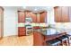 Kitchen featuring stainless steel appliances, granite countertops and dark wood cabinets at 251 Waterford Cove Dr, Suwanee, GA 30024