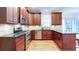 Kitchen featuring stainless steel appliances, granite countertops and dark wood cabinets at 251 Waterford Cove Dr, Suwanee, GA 30024
