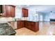 Kitchen featuring stainless steel appliances, granite countertops and dark wood cabinets at 251 Waterford Cove Dr, Suwanee, GA 30024