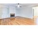 Bright living room featuring hardwood floors, a fireplace, and custom built-in shelving at 251 Waterford Cove Dr, Suwanee, GA 30024