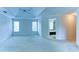 Expansive main bedroom featuring a tray ceiling, double windows, and an ensuite bathroom with a soaking tub at 251 Waterford Cove Dr, Suwanee, GA 30024