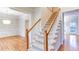 Carpeted staircase with wood railing ascends to the second floor, with views into the dining room at 251 Waterford Cove Dr, Suwanee, GA 30024