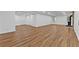 Open basement floor plan with wood-look flooring, white walls, and a black wood burning stove at 2935 Leafwood Se Dr, Marietta, GA 30067