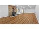 Large basement area with wood-look floors, brick accent wall, and a black wood burning stove at 2935 Leafwood Se Dr, Marietta, GA 30067