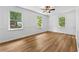 Well-lit bedroom showcases wood-look flooring, neutral paint, and multiple windows offering views of the property at 2935 Leafwood Se Dr, Marietta, GA 30067