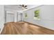 Airy bedroom showing wood-look flooring, large windows with natural light, a ceiling fan, and bi-fold closet at 2935 Leafwood Se Dr, Marietta, GA 30067