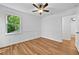 Bright bedroom features wood-look flooring, a ceiling fan, a window with a view, and neutral wall paint at 2935 Leafwood Se Dr, Marietta, GA 30067
