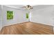 Bright bedroom showcases wood-look flooring, neutral paint, a ceiling fan, and multiple view-enhancing windows at 2935 Leafwood Se Dr, Marietta, GA 30067