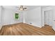 Spacious bedroom features wood-look flooring, neutral paint, a ceiling fan, and an entryway to another room at 2935 Leafwood Se Dr, Marietta, GA 30067