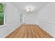Dining room featuring a modern chandelier, hardwood floors and wainscoting at 2935 Leafwood Se Dr, Marietta, GA 30067