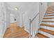 Bright entryway features hardwood floors, wainscoting, and staircase to the second level at 2935 Leafwood Se Dr, Marietta, GA 30067