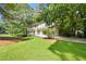Exterior view of home with green lawn and mature trees at 2935 Leafwood Se Dr, Marietta, GA 30067