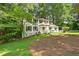 Charming two-story home with white siding, dark shutters, and a beautifully landscaped front yard at 2935 Leafwood Se Dr, Marietta, GA 30067
