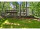 View of the rear exterior featuring a large deck, stairs and a grass-covered yard at 2935 Leafwood Se Dr, Marietta, GA 30067