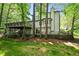 Home exterior featuring a multi-level deck, lush green lawn, and mature trees for privacy at 2935 Leafwood Se Dr, Marietta, GA 30067