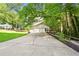 Exterior view showcasing a long driveway leading to a two-car garage with additional walkway at 2935 Leafwood Se Dr, Marietta, GA 30067