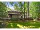 Charming home exterior with a large wooden deck, lush landscaping, and a serene backyard setting at 2935 Leafwood Se Dr, Marietta, GA 30067